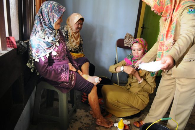 Leprosy health workers treating patients